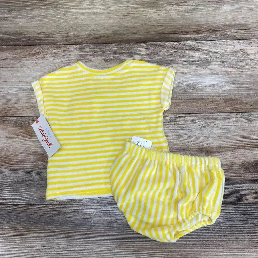 Flat lay of yellow and white striped terry shirt and matching shorts showing soft terry fabric and elastic waist on wooden background