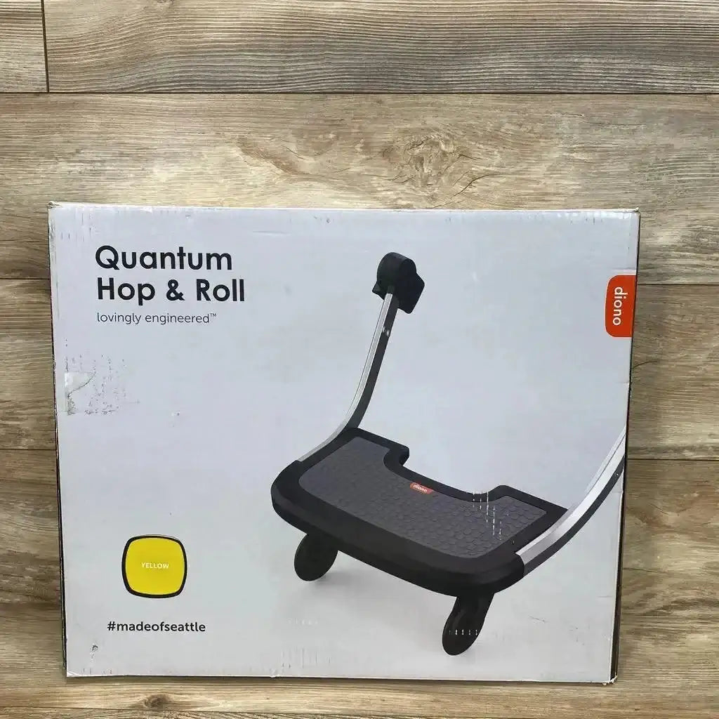 Front of boxed Diono Quantum Hop & Roll buggy board showing product image, large headline and yellow color swatch on wood floor