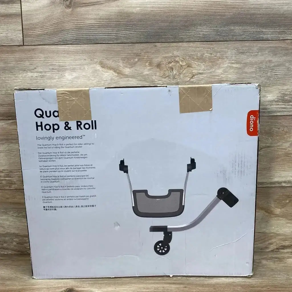 Front view of Diono Quantum Hop and Roll buggy board box showing product illustration, taped top, and orange Diono logo on wood floor background