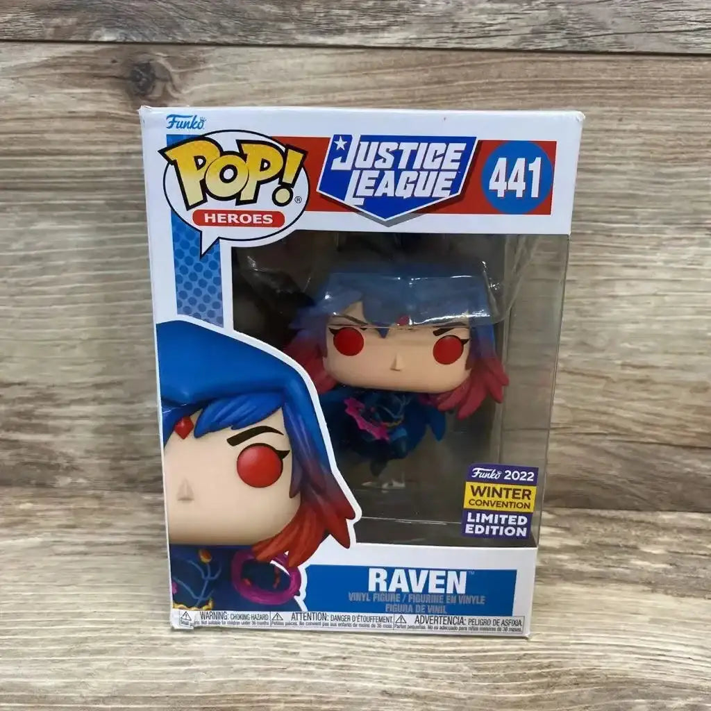 Front view of NEW Funko POP Heroes 441 Justice League Raven 2022 Winter Convention Limited Edition vinyl figure in box on wood plank floor