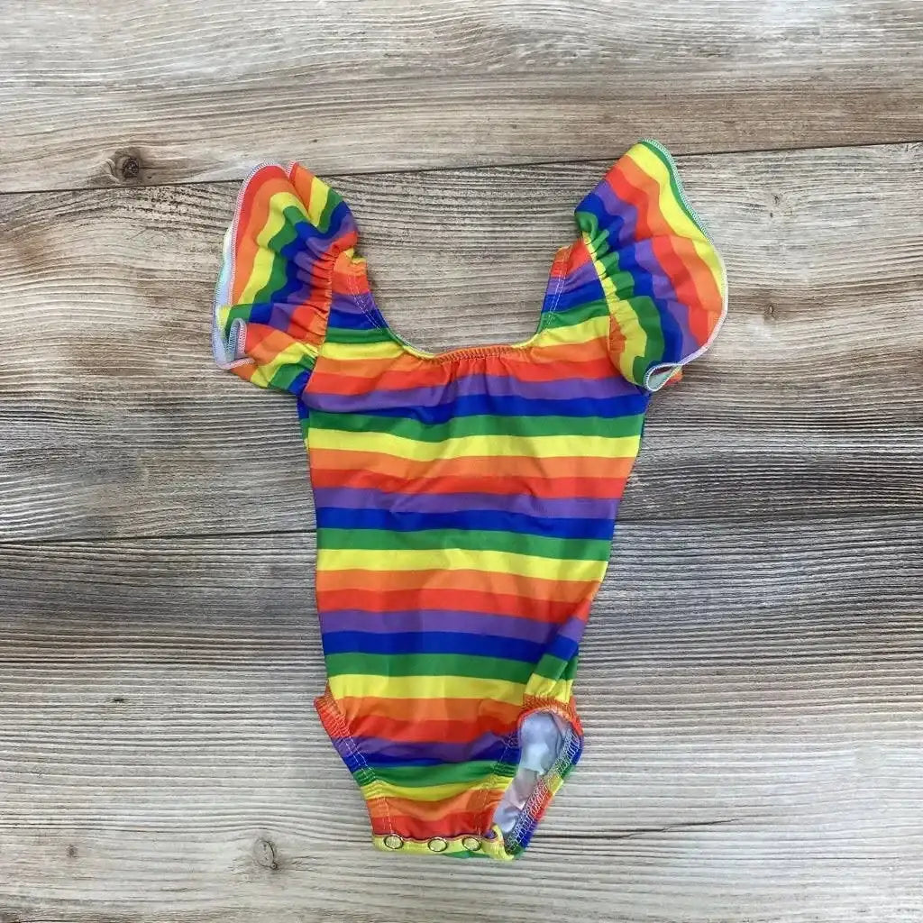 Flat lay of Syd & Mimi leotard, size 6–12 months, showing rainbow stripes, ruffle sleeves, and snap crotch on wood background