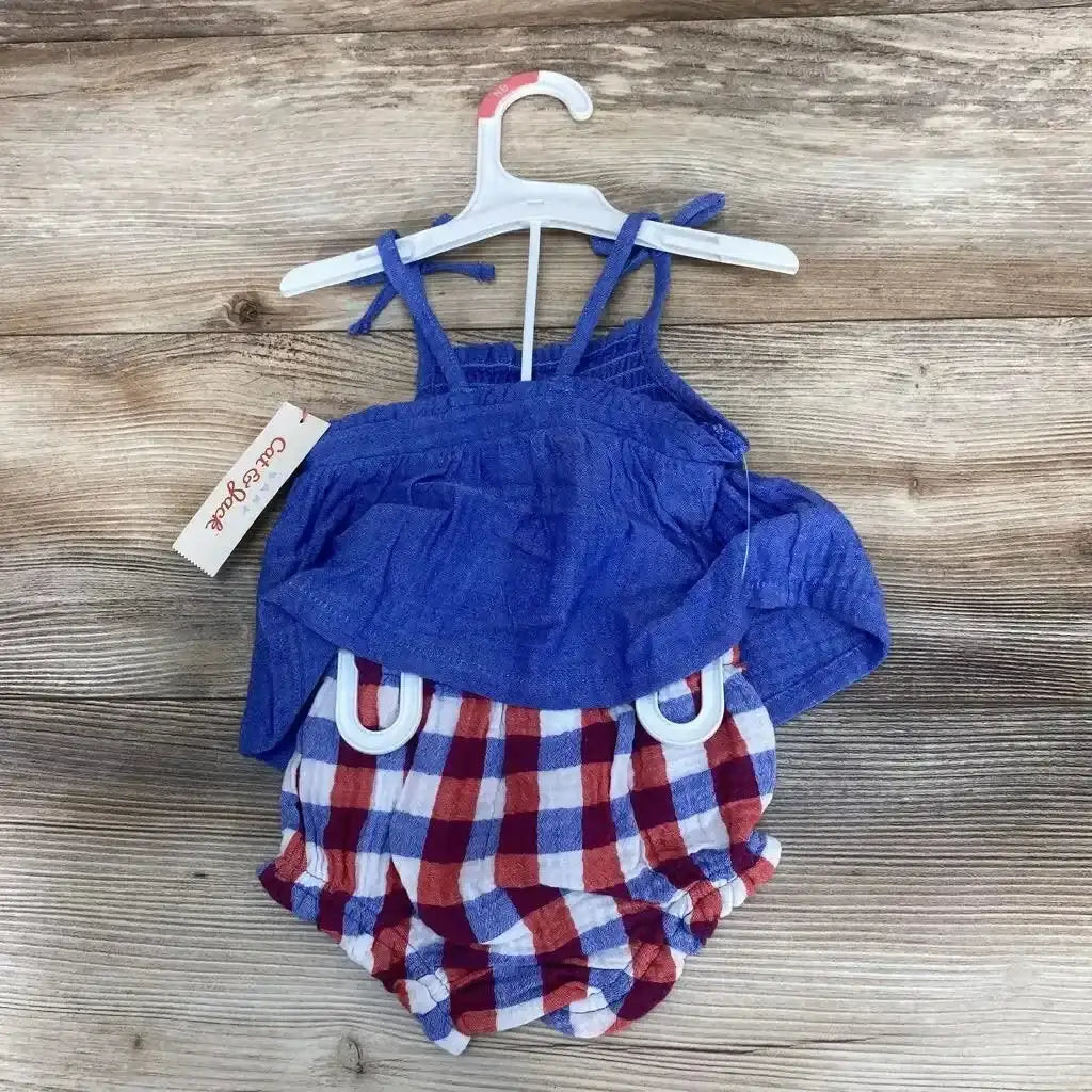 Front view of blue smocked sleeveless top with tie straps and red-white-blue plaid bloomers on hanger with wood background, size 3-6 months
