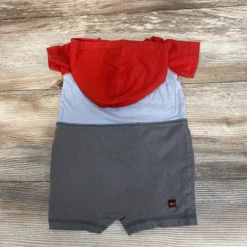 Flat-lay back of hooded colorblock romper with red hood, light blue middle and gray bottom, size 3–6 months on wood background