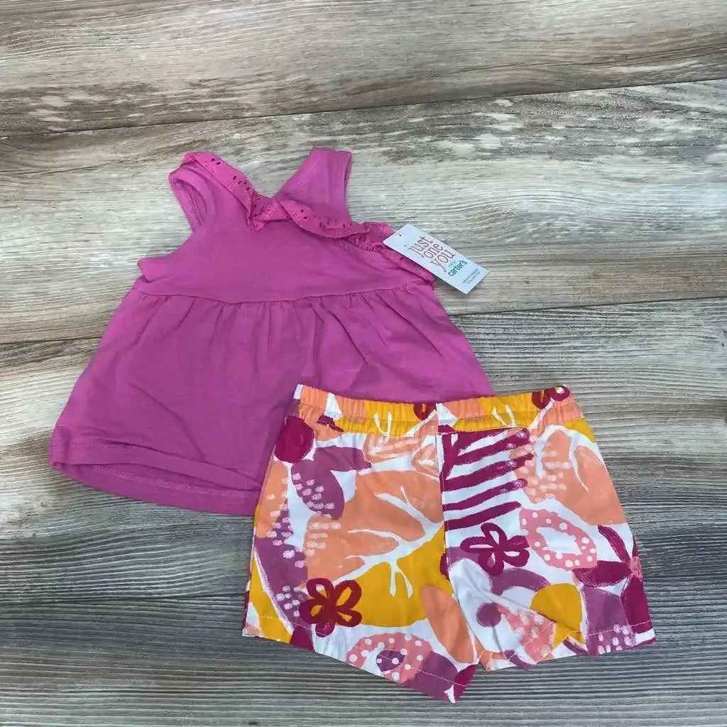 Flat lay of NEW Just One You pink tank top and floral shorts size 3m showcasing visible hangtag and orange purple floral print on wood plank floor