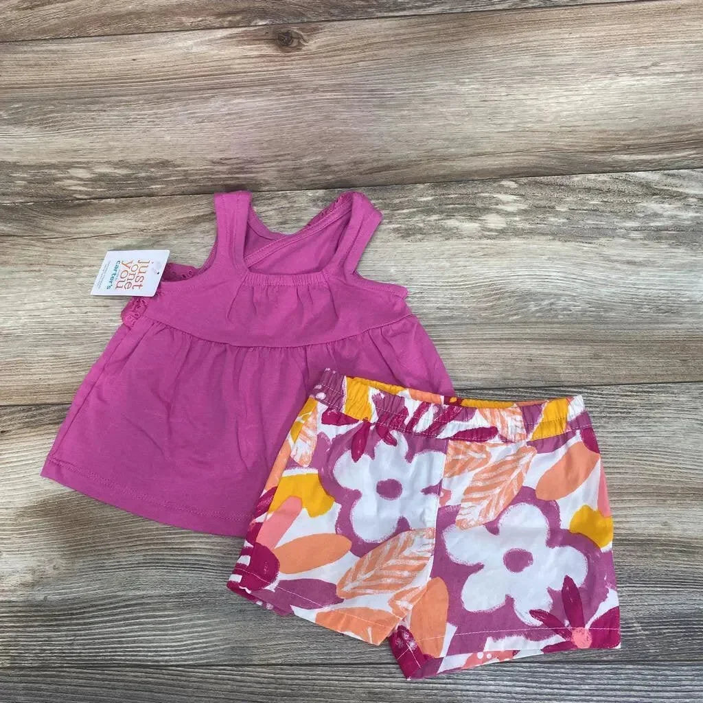 Flat lay of size 3M pink tank top and floral elastic-waist shorts showing empire seam and colorful flowers on wood background