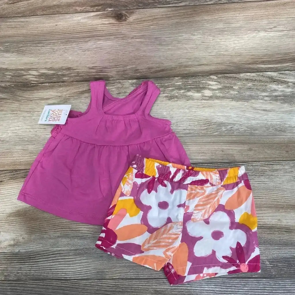 Flat lay of size 3M pink tank top and floral elastic-waist shorts showing empire seam and colorful flowers on wood background