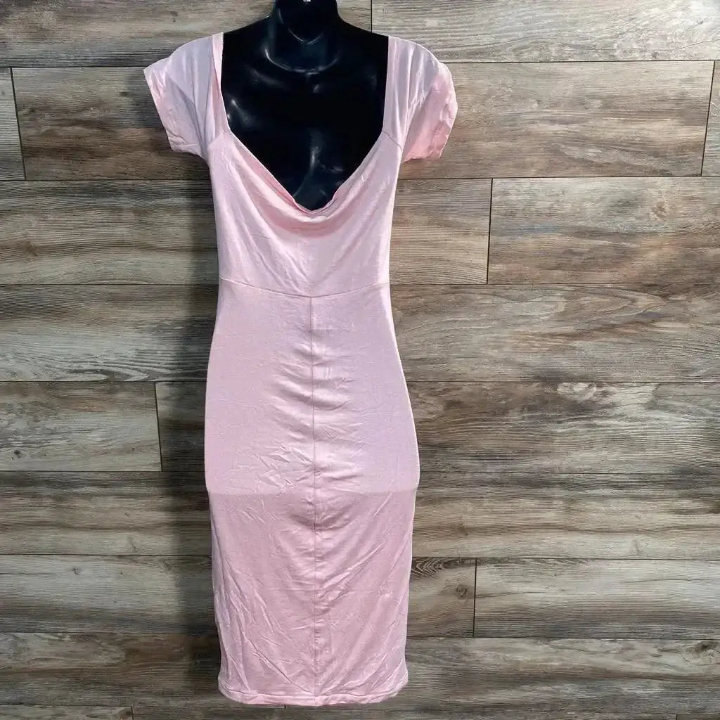 Front view of pink off-the-shoulder maternity dress with cowl neckline and short sleeves, fitted midi on wood background