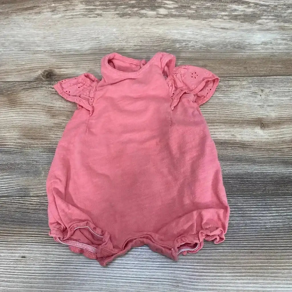 Front view of Carter’s Shortie Romper sz 3m showcasing its pink color and flutter sleeves on a wood-grain background