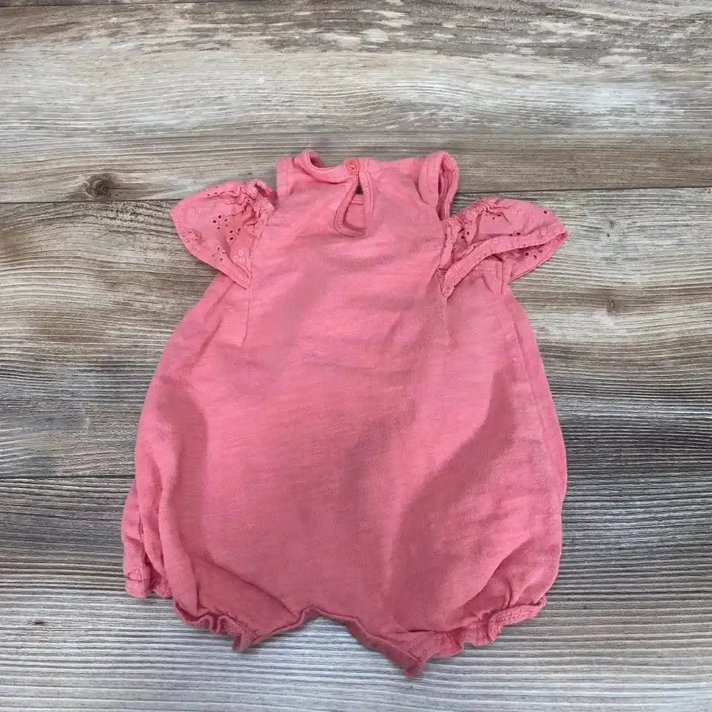 Front view of Carter’s Shortie Romper sz 3m showcasing pink color and eyelet flutter sleeves with a wood-grain background