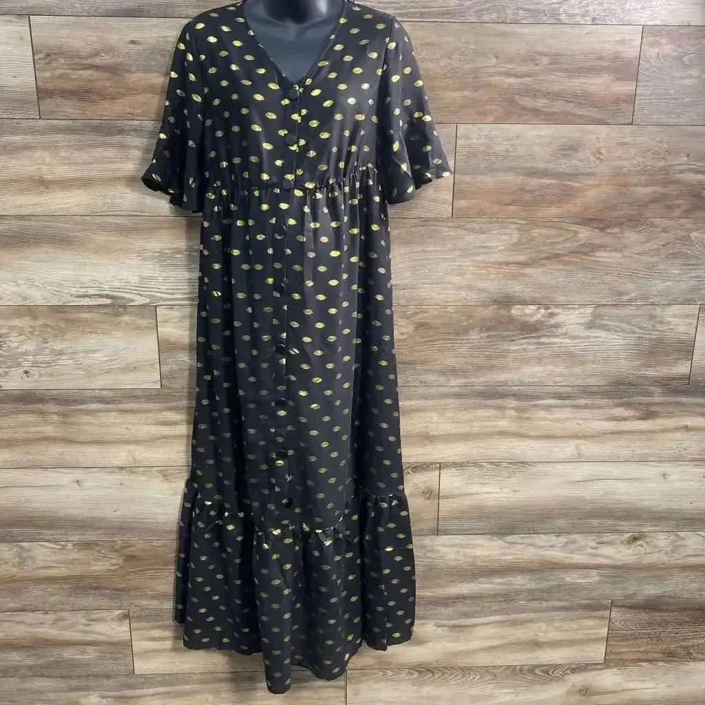 Front view of black polka dot maternity maxi dress with button-front closure and empire waist on white background