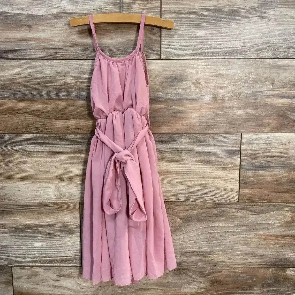 Front view of Bailey’s Blossoms Sleeveless Dress size 9-12m showcasing dusty pink spaghetti strap dress with tie waist on hanger against wood plank wall