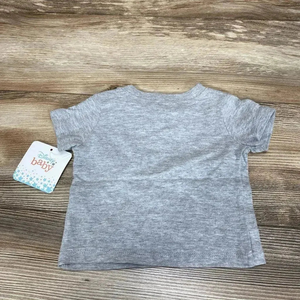 Back view of newborn grey heather Disney Baby T-shirt showcasing short sleeves and attached Disney Baby tag on wood background