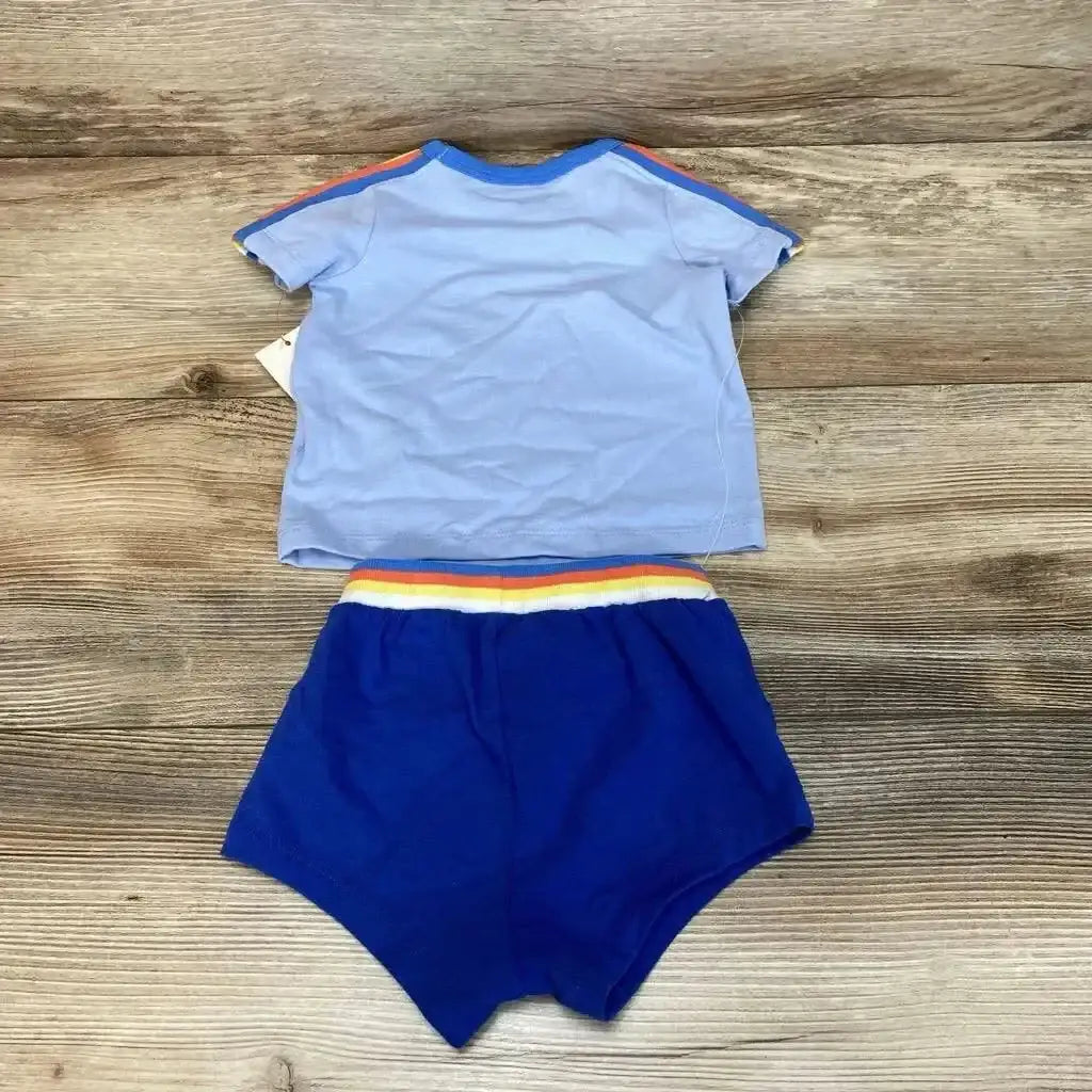 Flat lay of Cat and Jack light blue tee with rainbow shoulder stripes and royal blue shorts with hangtag on wood plank background