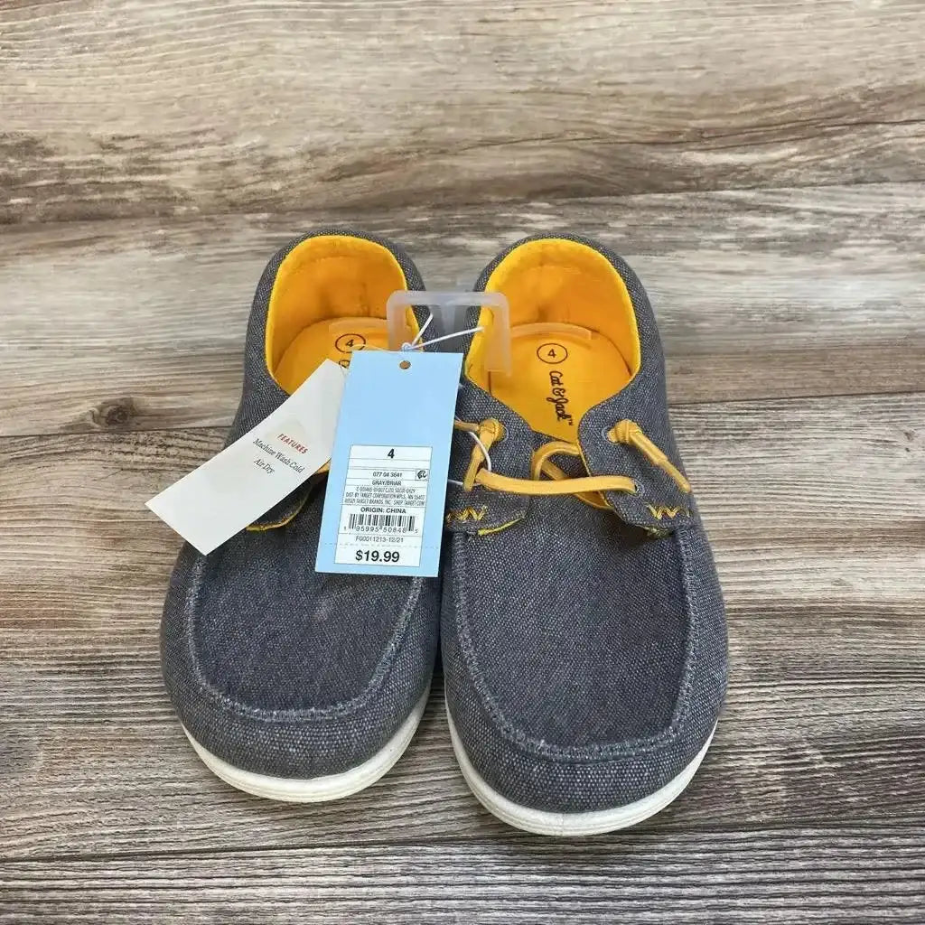 Front view of grey Cat & Jack Briar slip-on toddler sneakers showing yellow lining and attached size and price tags on wooden floor