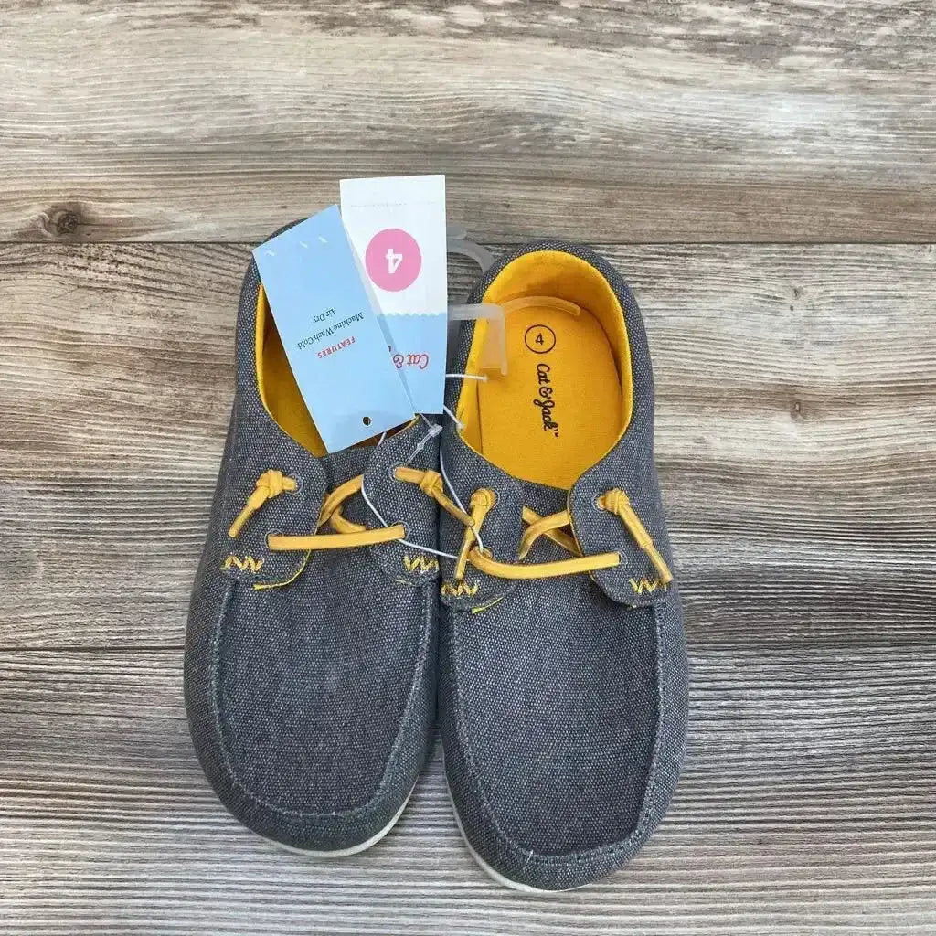 Top view of NEW Cat and Jack Briar slip-on sneakers in gray chambray with yellow elastic laces and lining with hangtag on wood plank floor