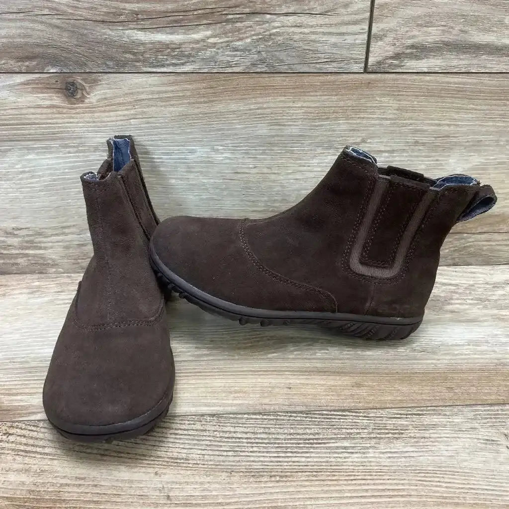 Three-quarter view of brown Bogs Wall Ball Chelsea toddler boots showing elastic side gore and rubber sole on wood background