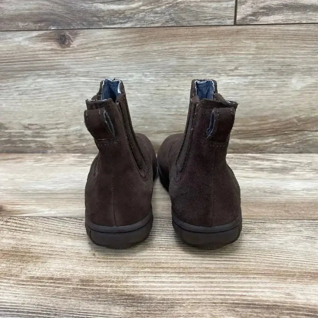 Rear view of Bogs Wall Ball Chelsea boots size 1Y showcasing brown suede, pull tabs, and elastic side panels on wooden floor background