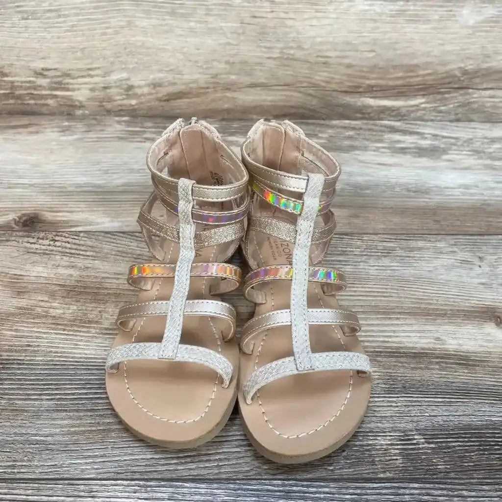 Three quarter view of gold Arizona Jean Co. Angel gladiator toddler sandal size 12C showing strappy upper and buckle on white background
