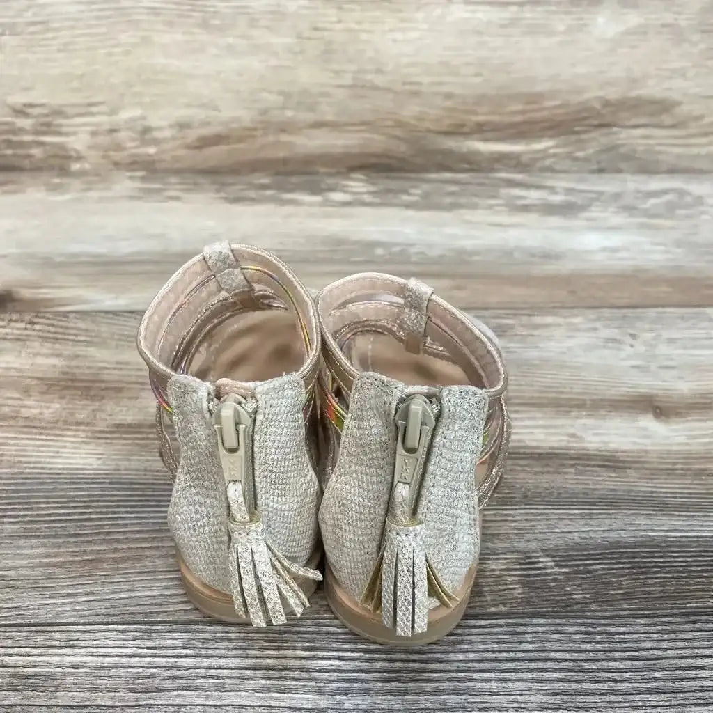 Three quarter view of gold Arizona Jean Co. Angel gladiator toddler sandal size 12C showing strappy upper and buckle on white background