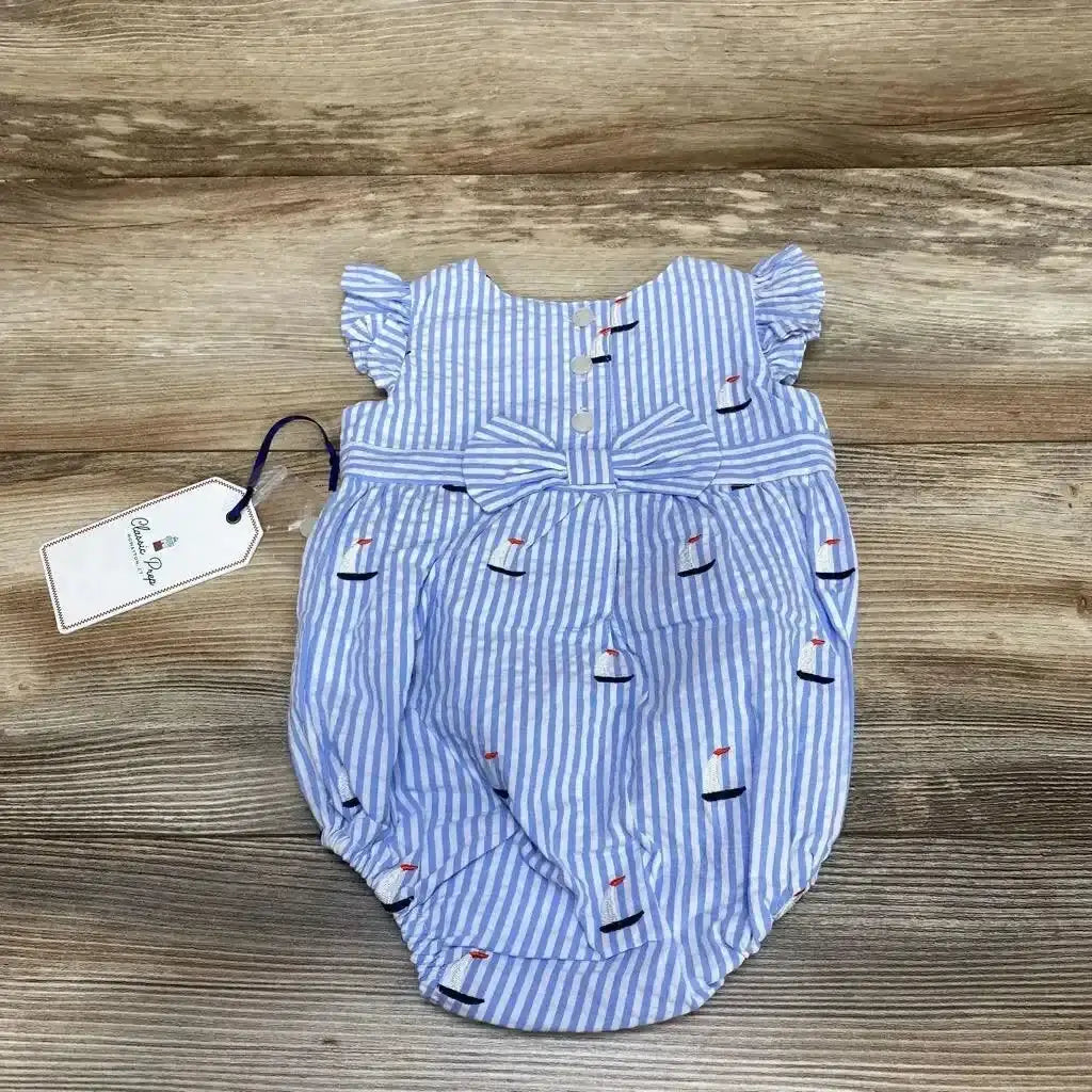 Front view of Classic Prep seersucker bubble romper showcasing blue and white stripes, ruffled sleeves, bow, and embroidery