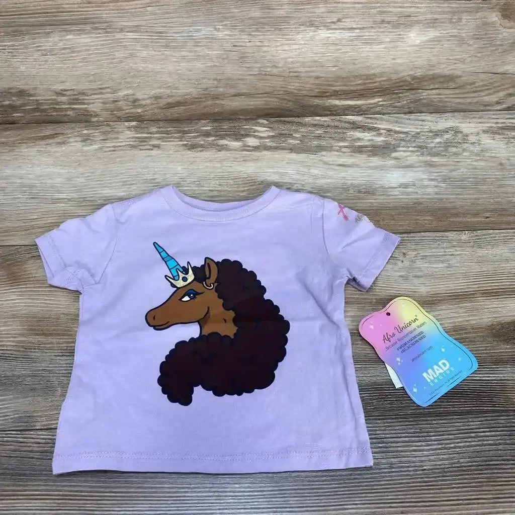 Front view of purple 12-month short-sleeve toddler shirt showcasing Afro unicorn graphic with crown on wood background