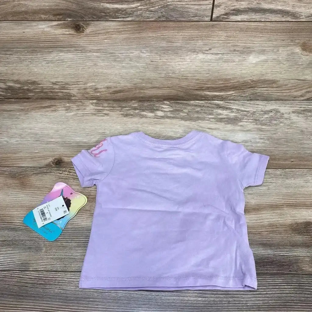 Back view of purple Afro Unicorn toddler short-sleeve shirt showing plain back and attached tags on wood background
