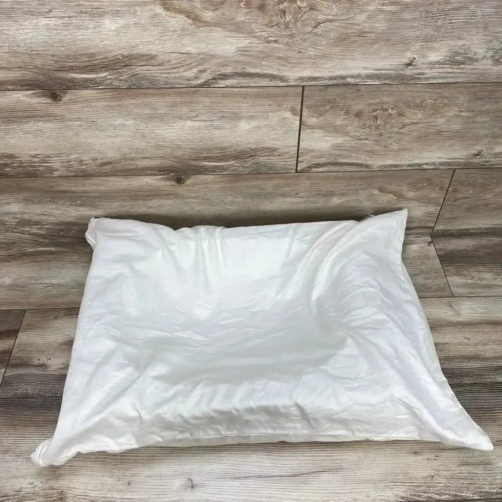Top view of Belly Baby Breast pregnancy pillow in white with soft cover on wood plank floor