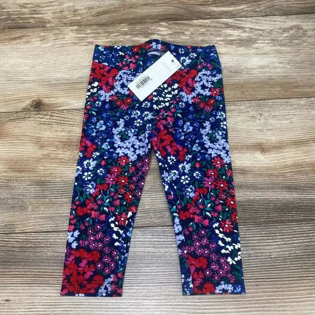 Front view of Janie and Jack floral ponte pants in size 6 to 12 months with elasticized waist on wood background