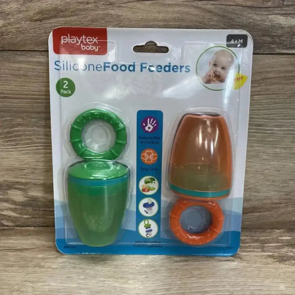 Front view of two-pack Playtex silicone food feeders, green and orange with protective caps on wood background