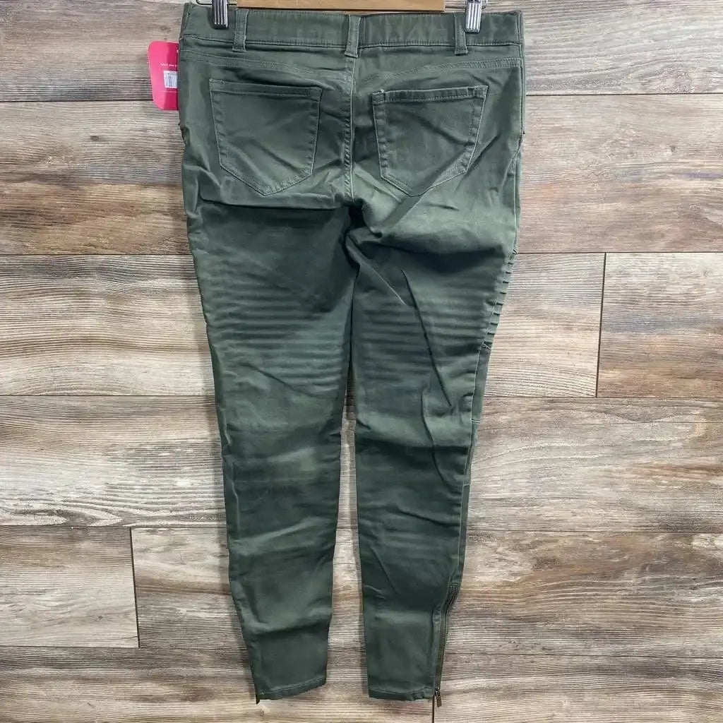 Back view of olive Isabel maternity utility jeggings, size 00, showing back pockets, ribbed knee detail and ankle zippers on wood floor