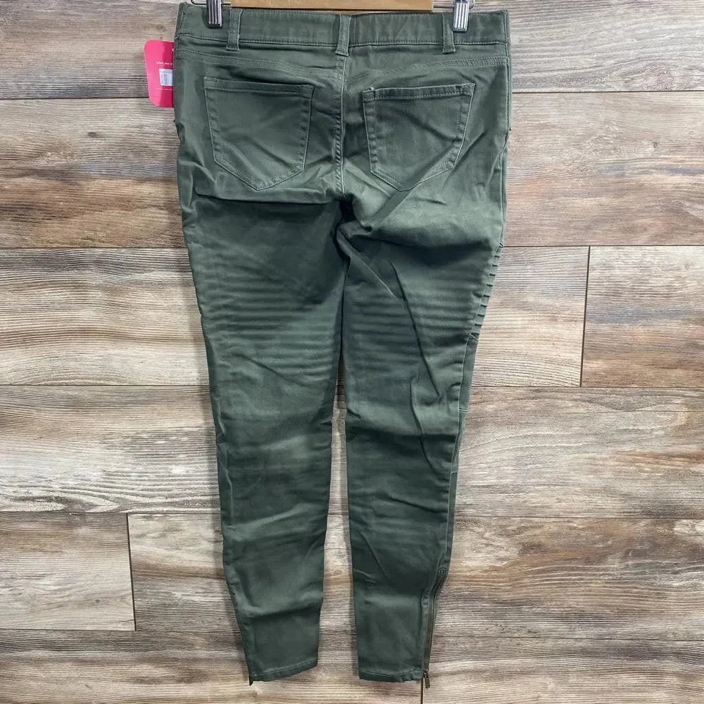 Back view of olive Isabel maternity utility jeggings, size 00, showing back pockets, ribbed knee detail and ankle zippers on wood floor