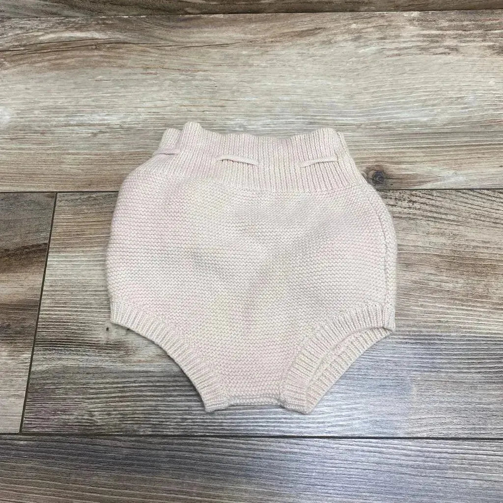 Front view of Karibou Gracie Knit Bloomers sz 2T in light pink, showcasing high waist and adjustable waist on a wood-grain surface