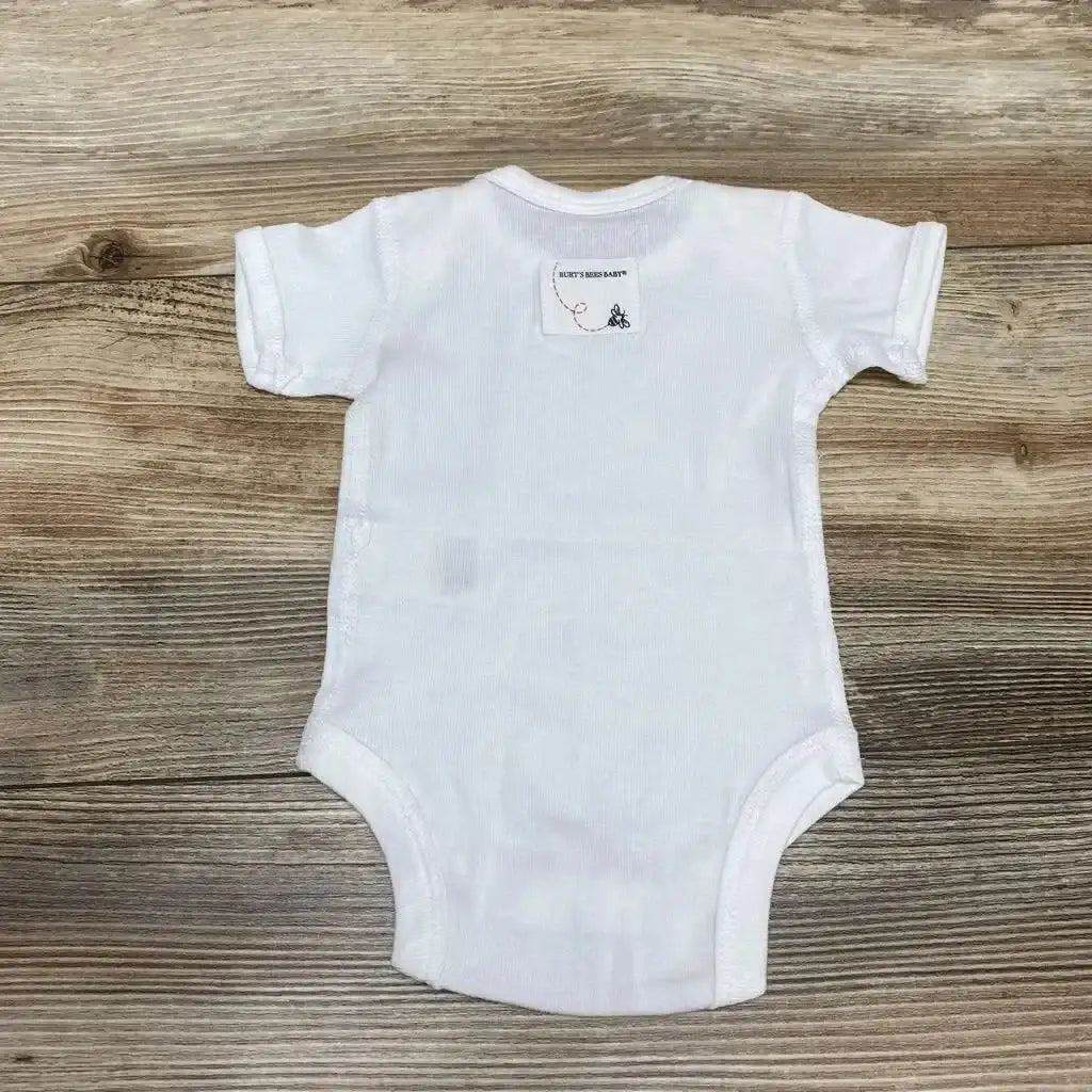 Front view of Burt’s Bees Baby Bodysuit sz PREEMIE showcasing its white short-sleeve design on a wood-grain background
