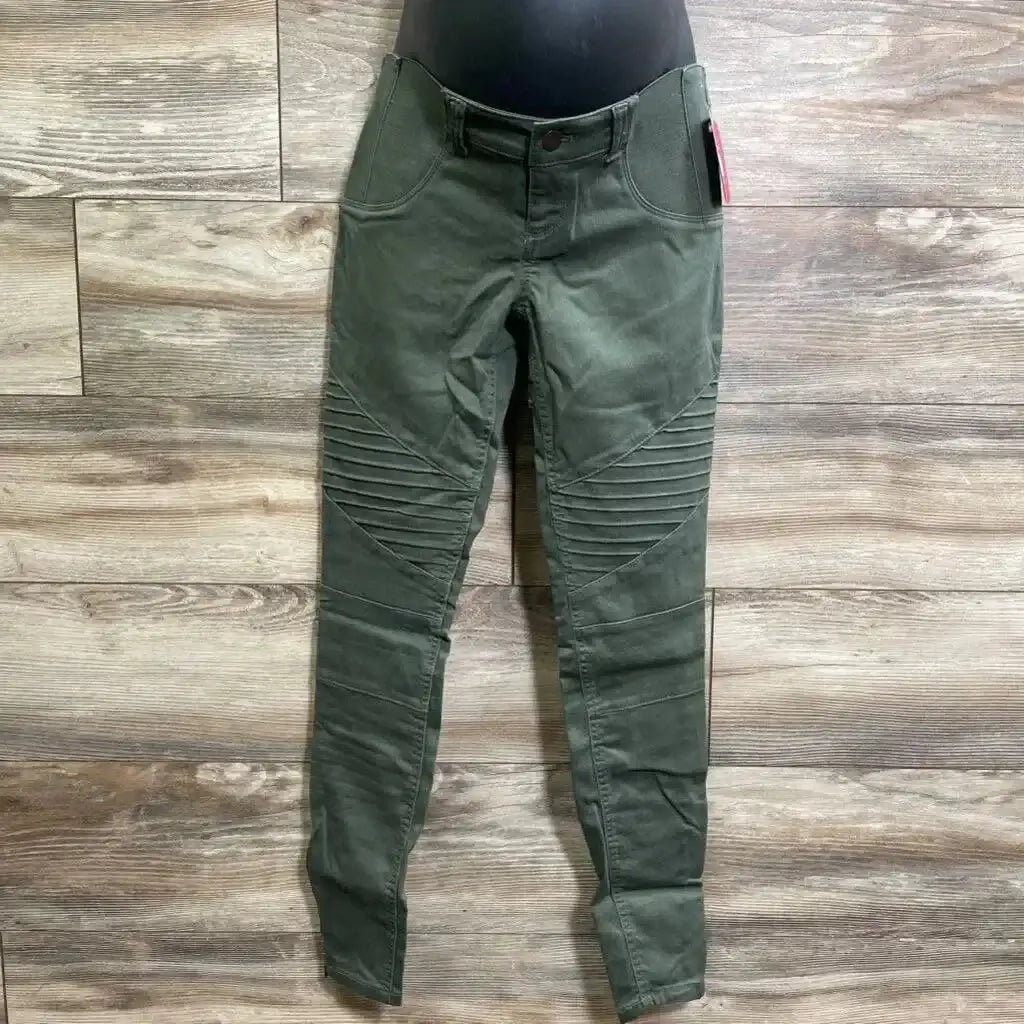 Front view of olive maternity jeggings size 00 with ribbed moto knee panels, front pockets and over-belly panel on wood floor