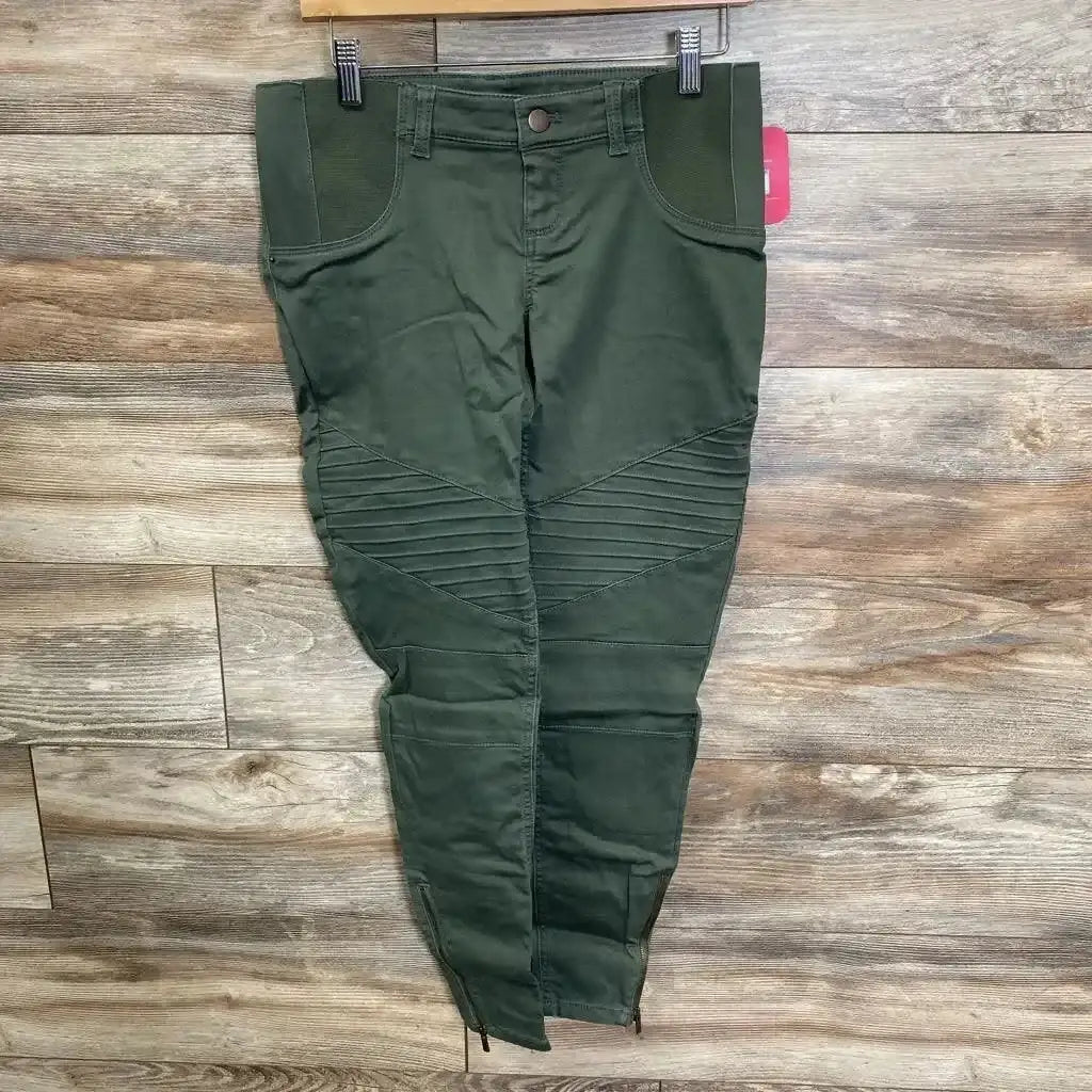Front view of olive utility maternity jeggings with ribbed knee panels, elastic waistband, and ankle zippers on wood background