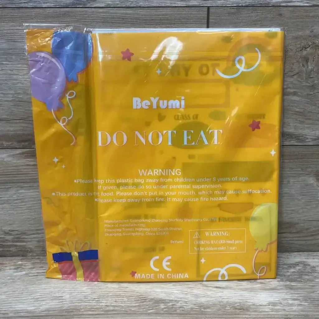 Front view of Beyumi First/Last Day of School sign in orange packaging showing 'DO NOT EAT' warning text on wood floor