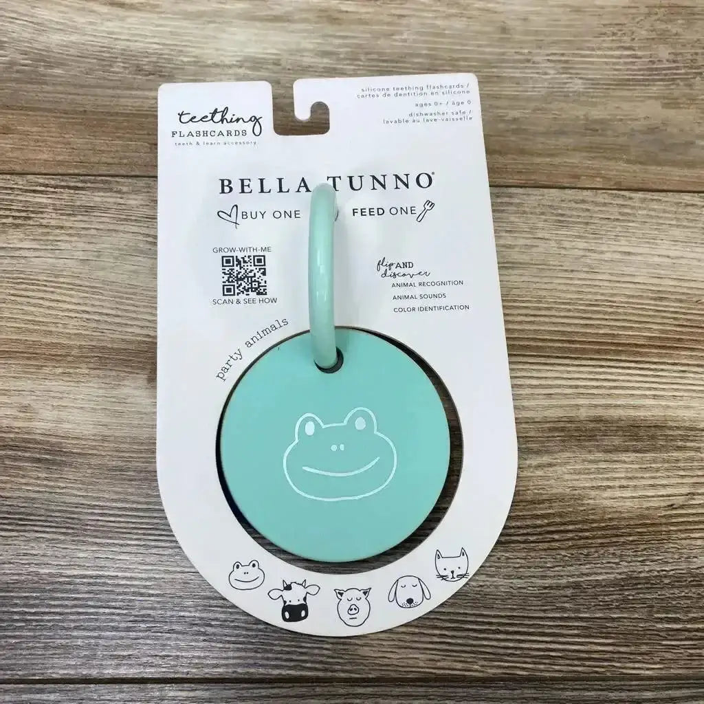 Front view of Bella Tunno Party Animals silicone teething flashcard in mint showing frog face and ring on wood background