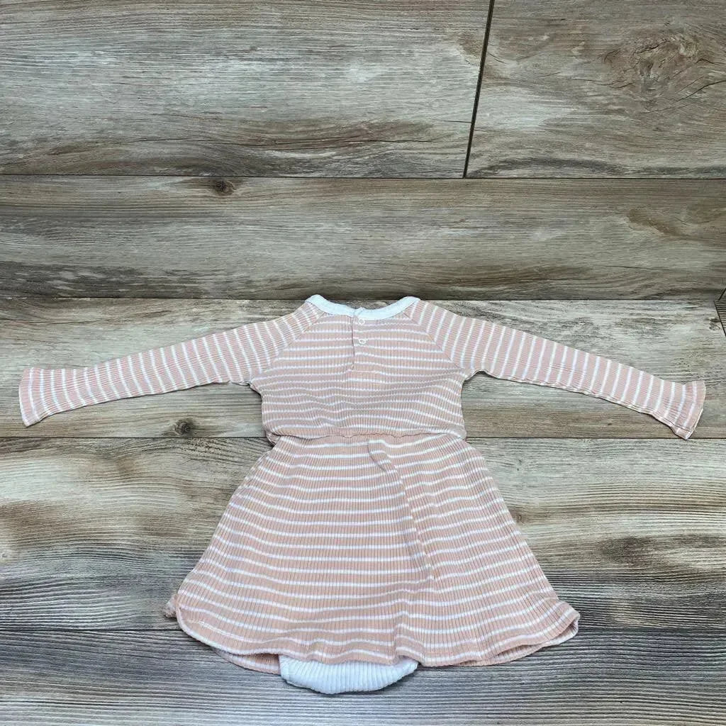Flat lay of pink and white striped long-sleeve bodysuit dress showcasing snap closure and flared skirt on wood background