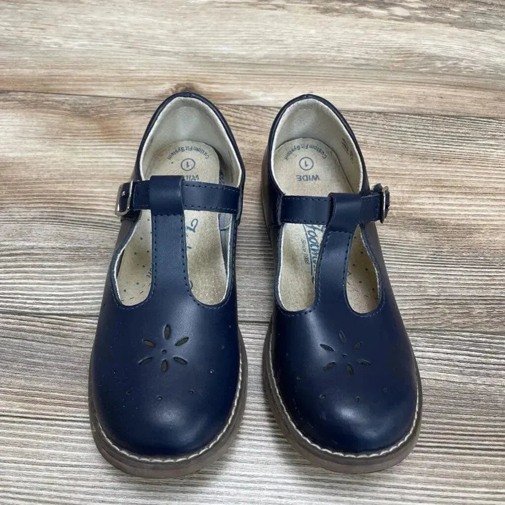 Top view of navy Footmates Sherry Mary Jane toddler shoes size 1Y with T-strap buckle and floral toe cutouts on wood floor