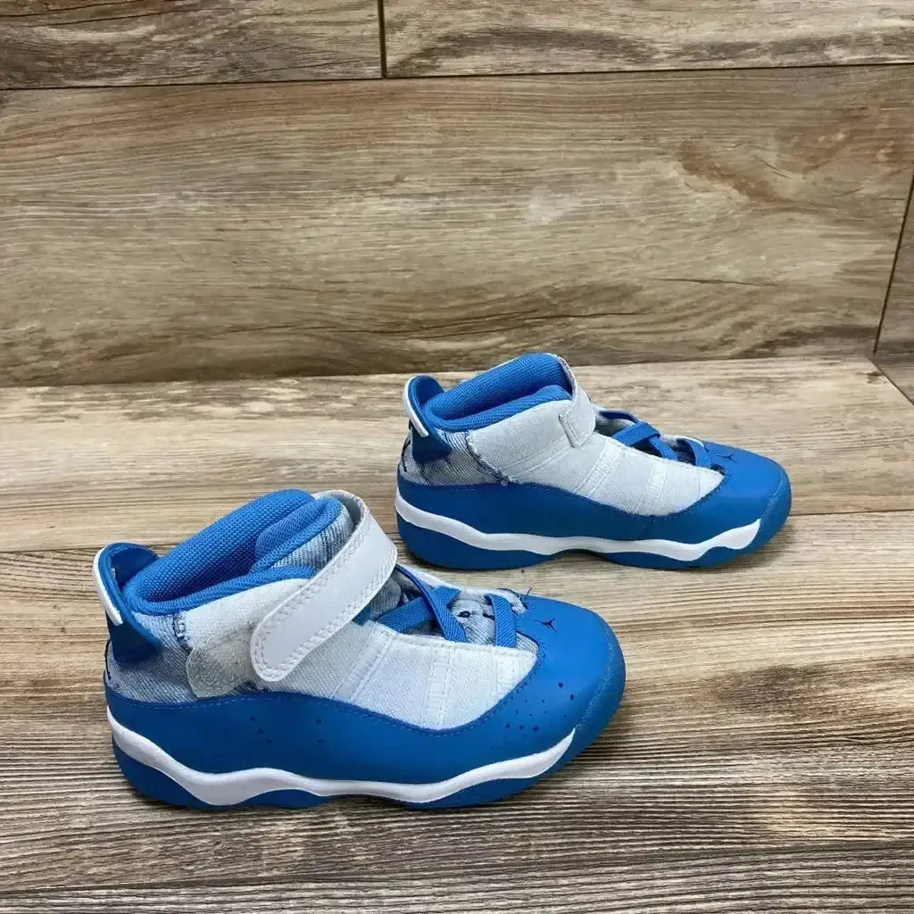 Side view of Jordan 6 Rings TD White Dutch Blue Sneakers sz 10c with hook-and-loop strap and elephant print panel on wood plank floor