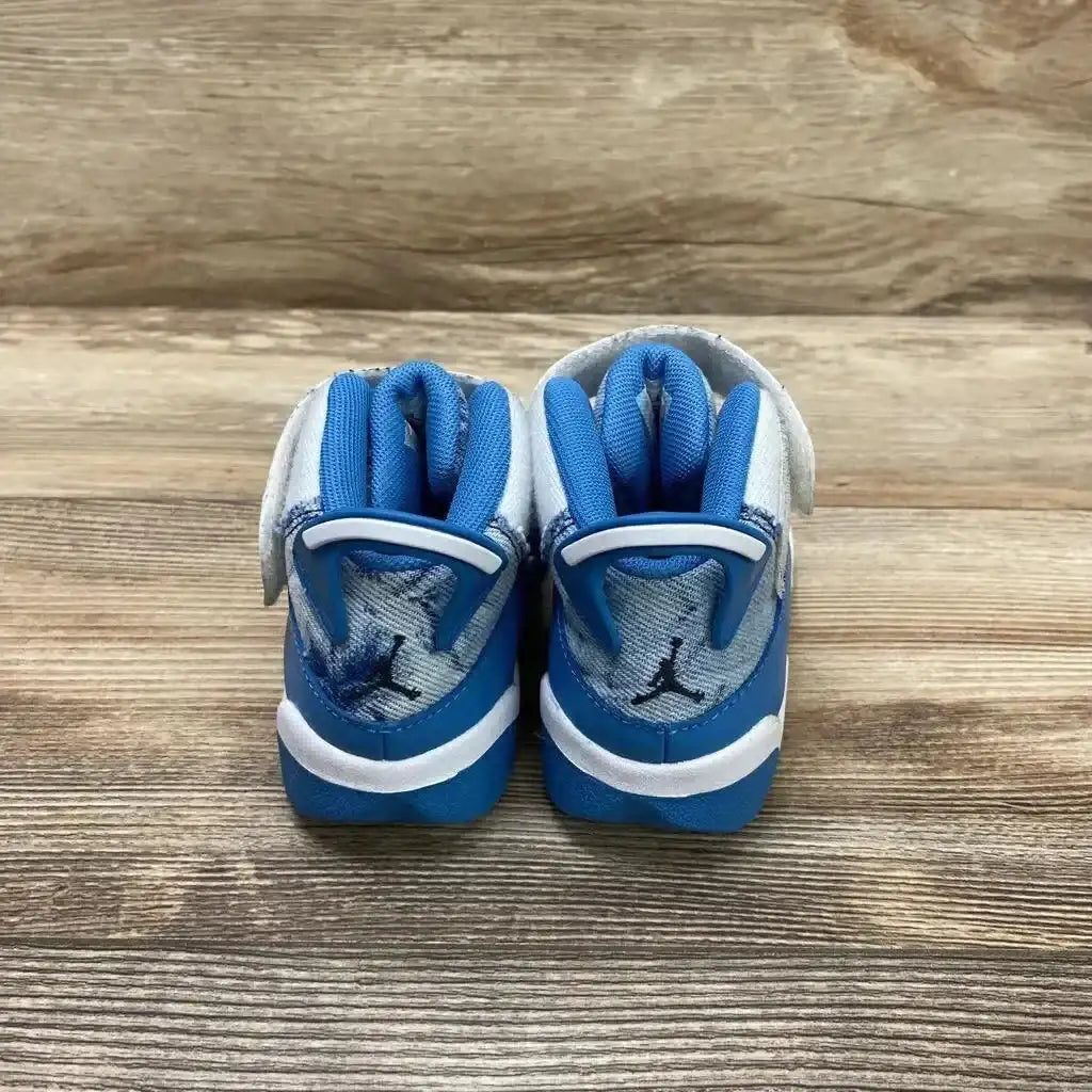 Back view of Jordan 6 Rings TD White Dutch Blue toddler sneakers showcasing blue heel tabs and Jumpman logo on wood plank floor