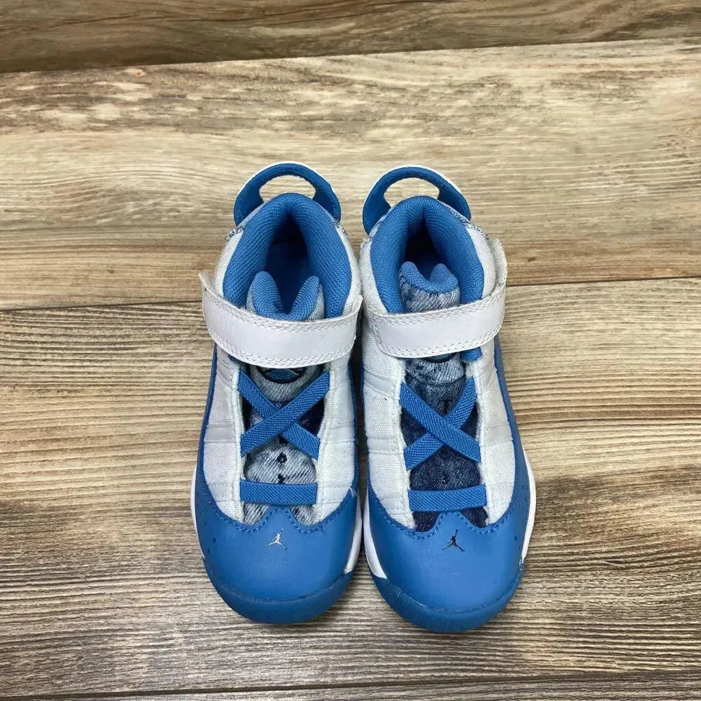 Top view of Jordan 6 Rings TD White Dutch Blue Sneakers showcasing blue and white upper hook-loop strap with Jumpman logo on wood plank floor