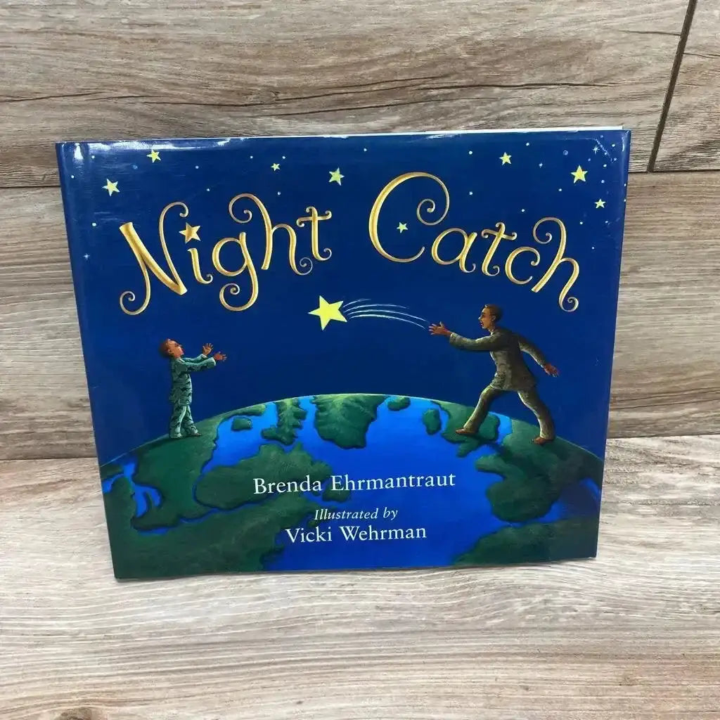 Front cover of Night Catch hardcover children's book showing two people on a globe tossing a star, photographed on wood floor