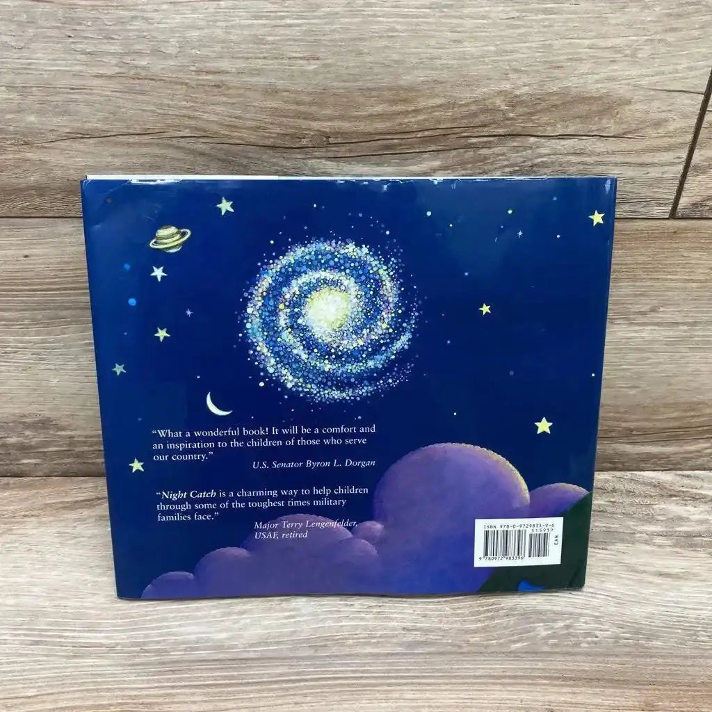Back cover view of Night Catch hardcover book showcasing starry night sky with galaxy and purple clouds illustration on wood plank floor