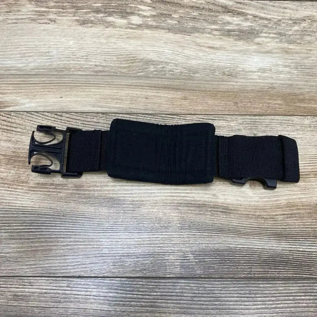 Top-down view of LILLEbaby waistbelt extension in black, 9 inch, showing padded center panel and quick-release buckles on wood background