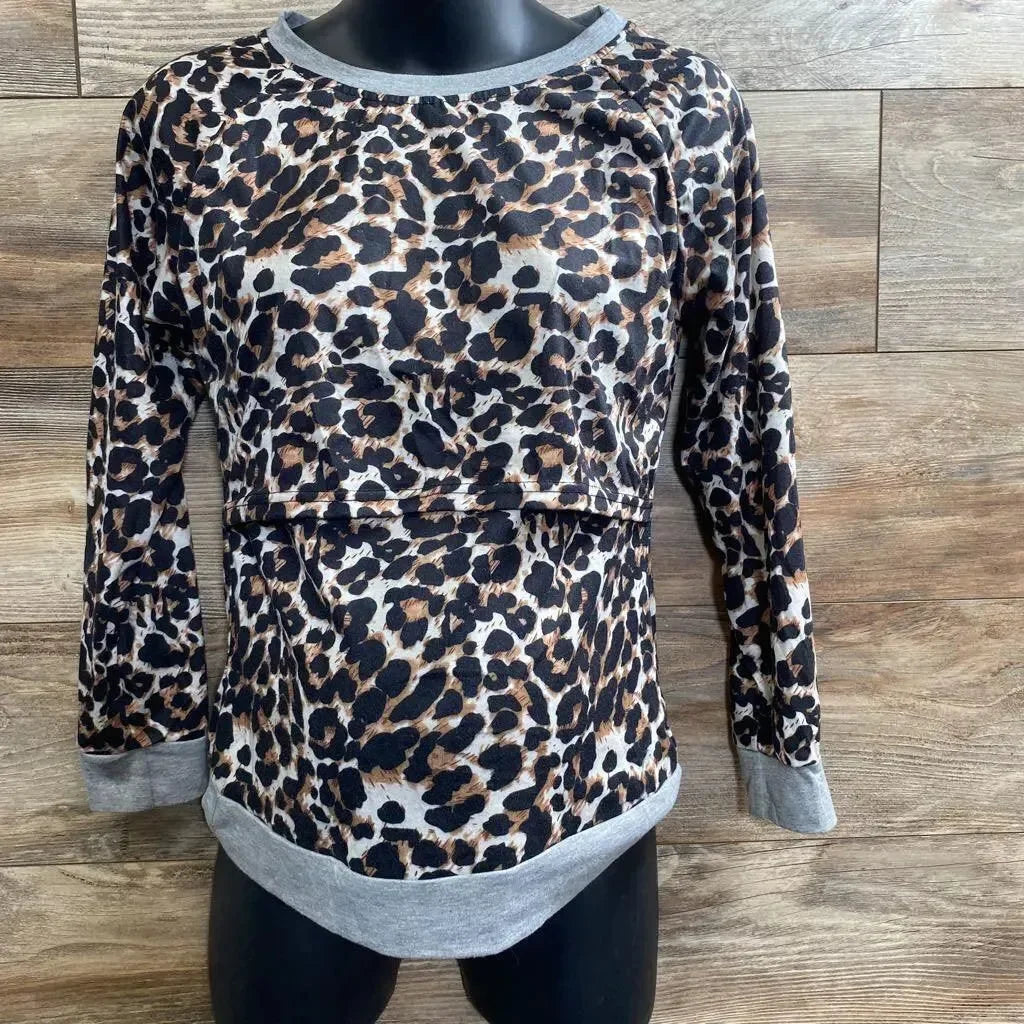 Front view of leopard-print nursing shirt with hidden nursing panel, grey trim, on black mannequin against wood background