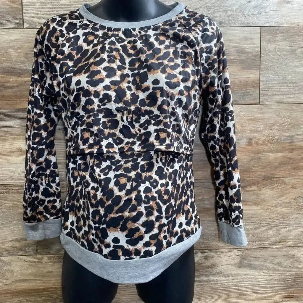 Front view of leopard-print nursing shirt with hidden nursing panel, grey trim, on black mannequin against wood background