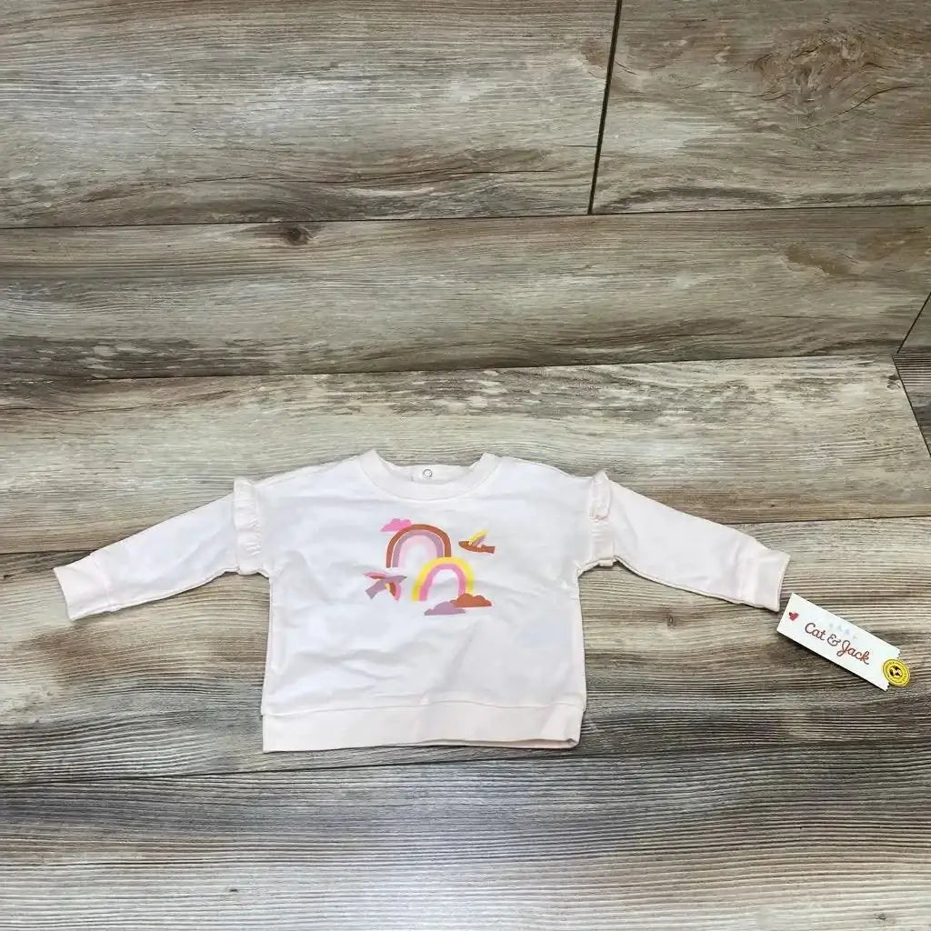 Front view of pink Cat & Jack baby sweatshirt (0-3m) showcasing rainbow chest graphic on white background