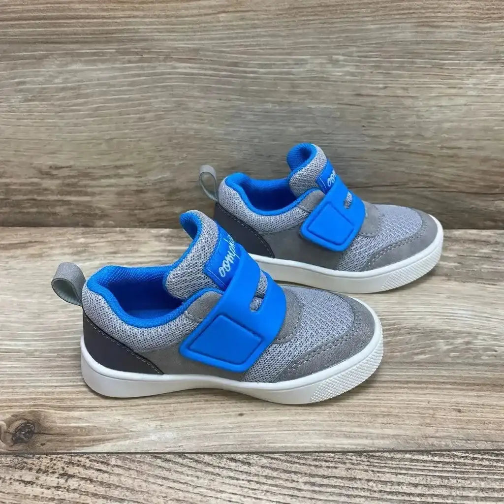 Side view of Oomphies Devon toddler sneakers, grey mesh with blue velcro strap, size 7C, on wooden background