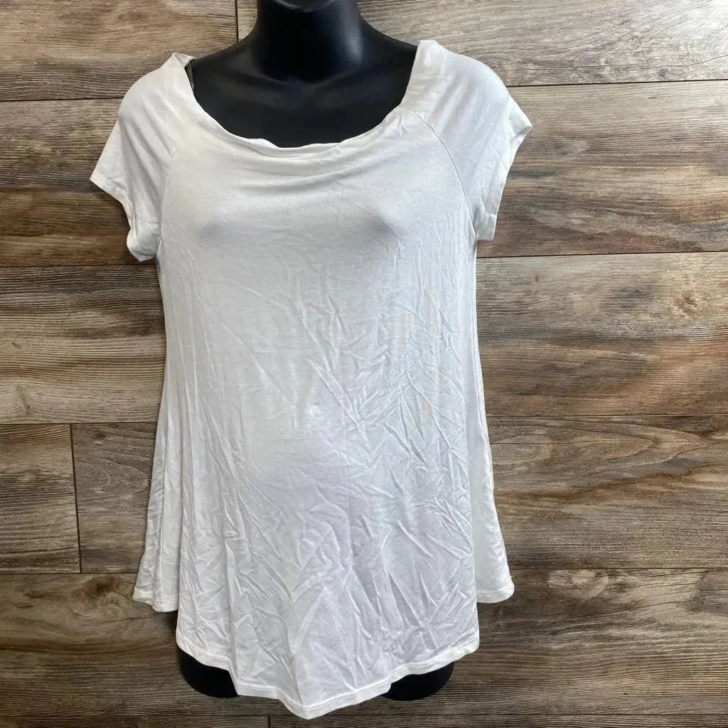 Front view of white maternity short-sleeve tunic showing flared hem and scoop neckline on black mannequin against wood background